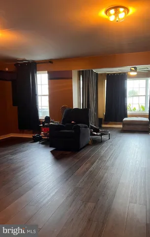 a living room with furniture window and wooden floor