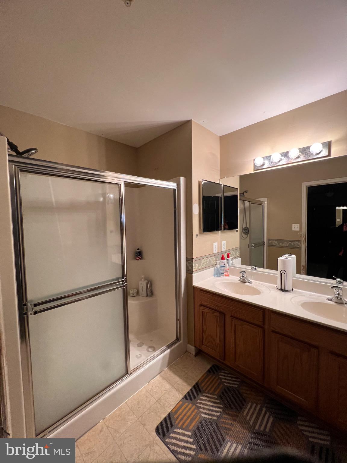 103 Canvasback Way Cambridge, MD 21613 - Photo 33 of 39 a bathroom with a double vanity sink mirror and shower