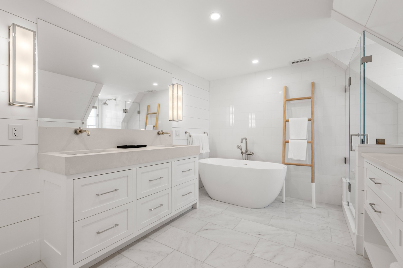174 Cliff Road Nantucket, MA 02554 - Photo 27 of 49 a large bathroom with a double vanity sink a large mirror and a bathtub