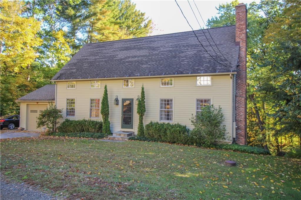 a front view of house with yard and trees