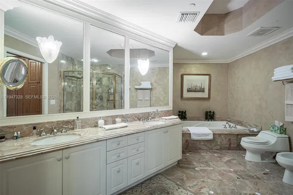 a bathroom with a double vanity sink mirror and toilet