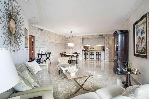 a living room with fireplace furniture and a chandelier