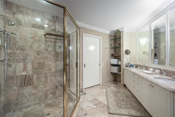 a bathroom with a double vanity sink toilet and shower