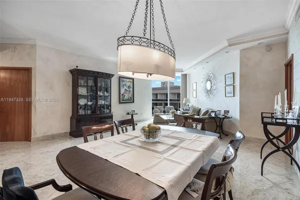 a dining room with large glass table and chairs