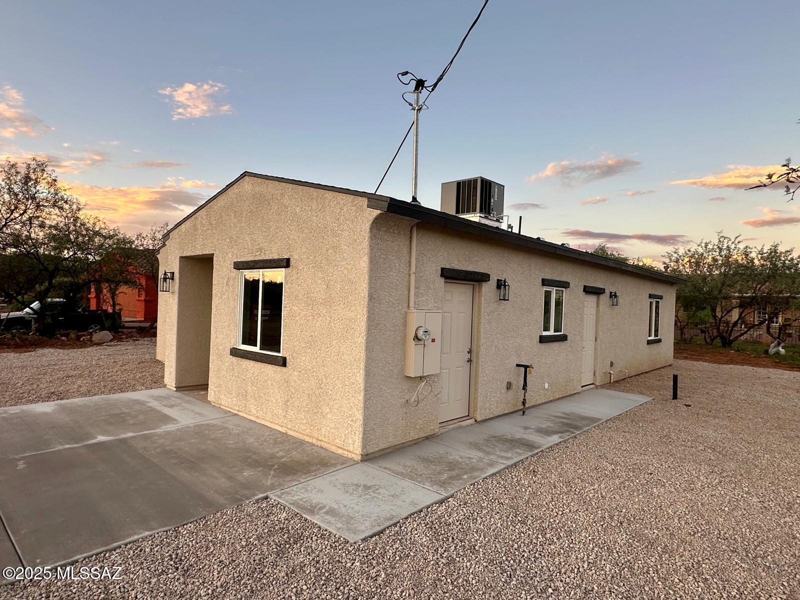 1845 Gardenias Court Rio Rico, AZ 85648 - Photo 6 of 19 a view of a white house with a large space in front of it
