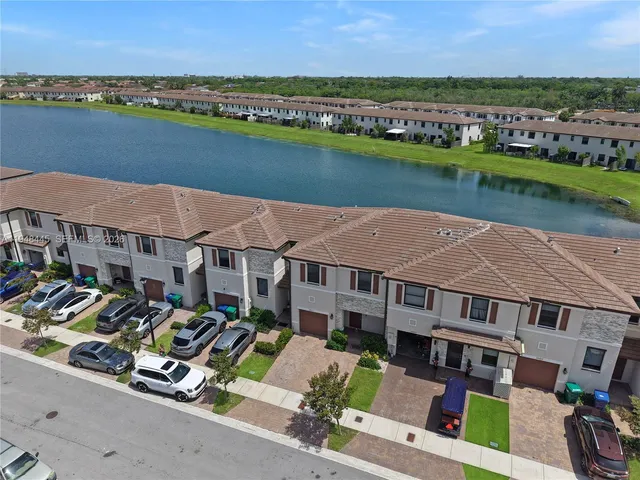 an aerial view of a house with a big yard