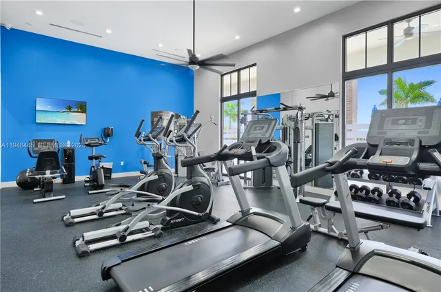 a room with gym equipment and large mirror