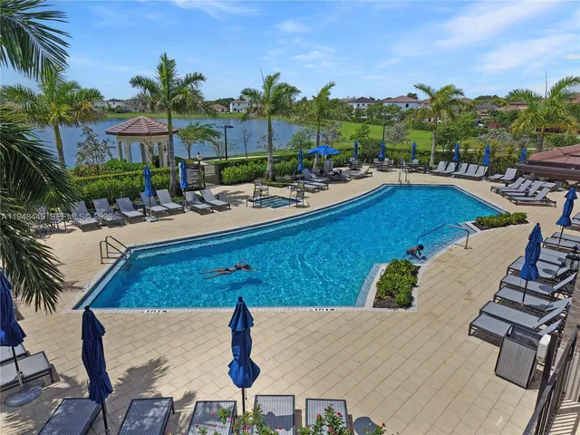 a view of a swimming pool and lounge chairs