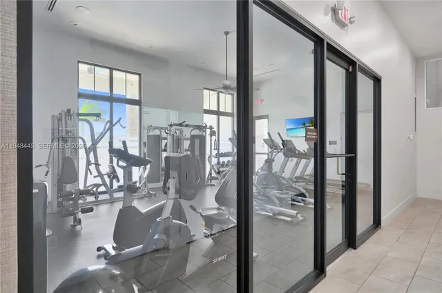 a room with gym equipment and large mirror