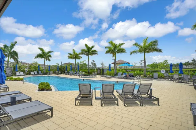 a view of a swimming pool and lounge chairs