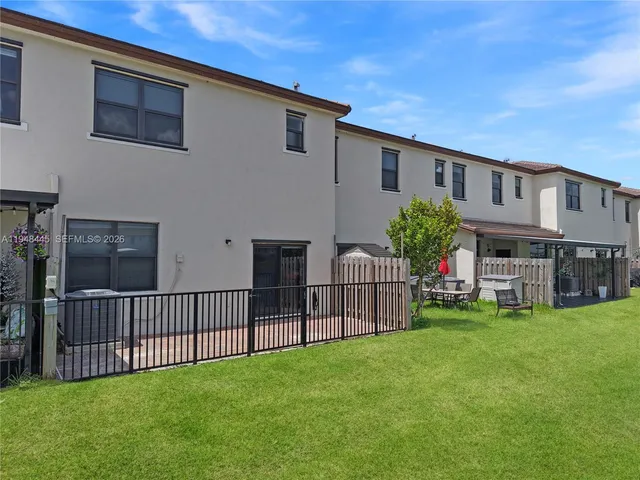 a view of a house with a yard and sitting area