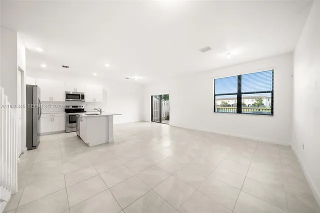 a view of kitchen with stainless steel appliances cabinets