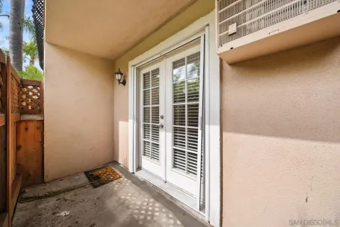 a view of a porch with a door and chair
