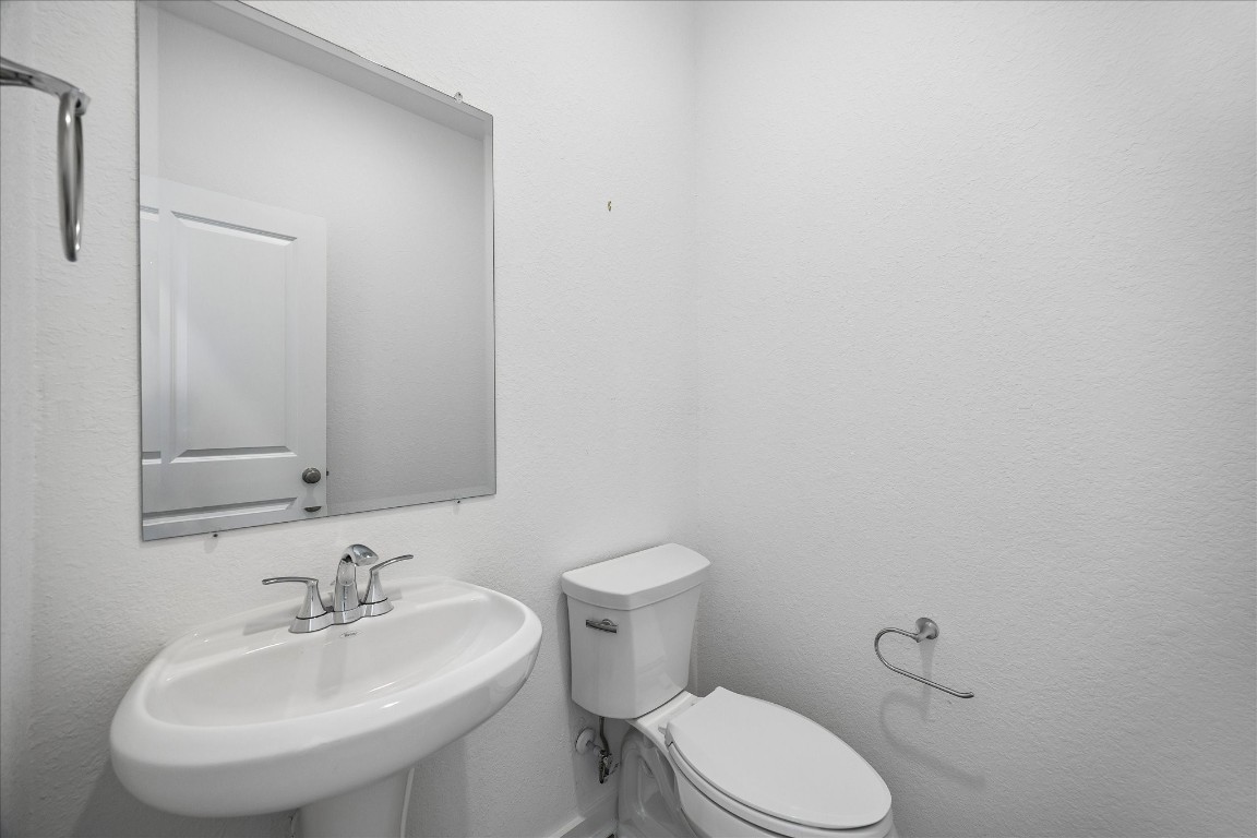 15823 Bird Of Conroe, TX 77302 - Photo 13 of 27 a bathroom with a sink a toilet and mirror