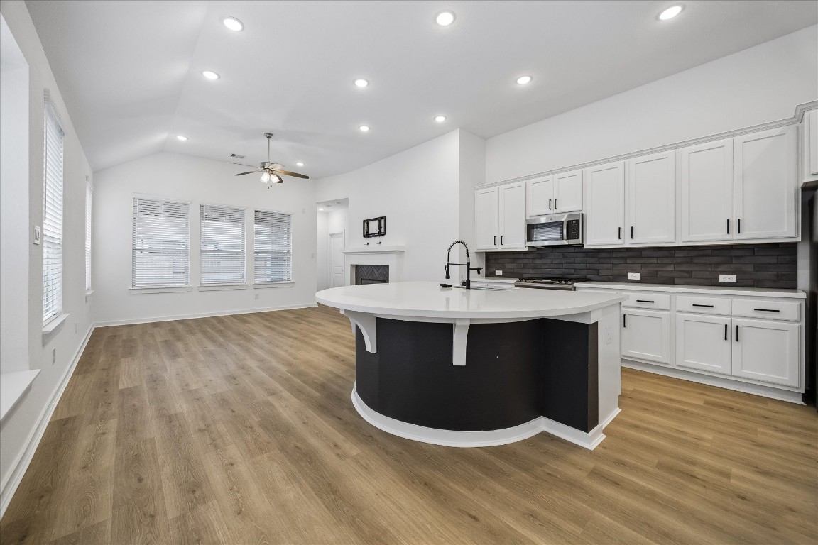 15823 Bird Of Conroe, TX 77302 - Photo 7 of 27 a kitchen with stainless steel appliances granite countertop a stove a sink and a microwave
