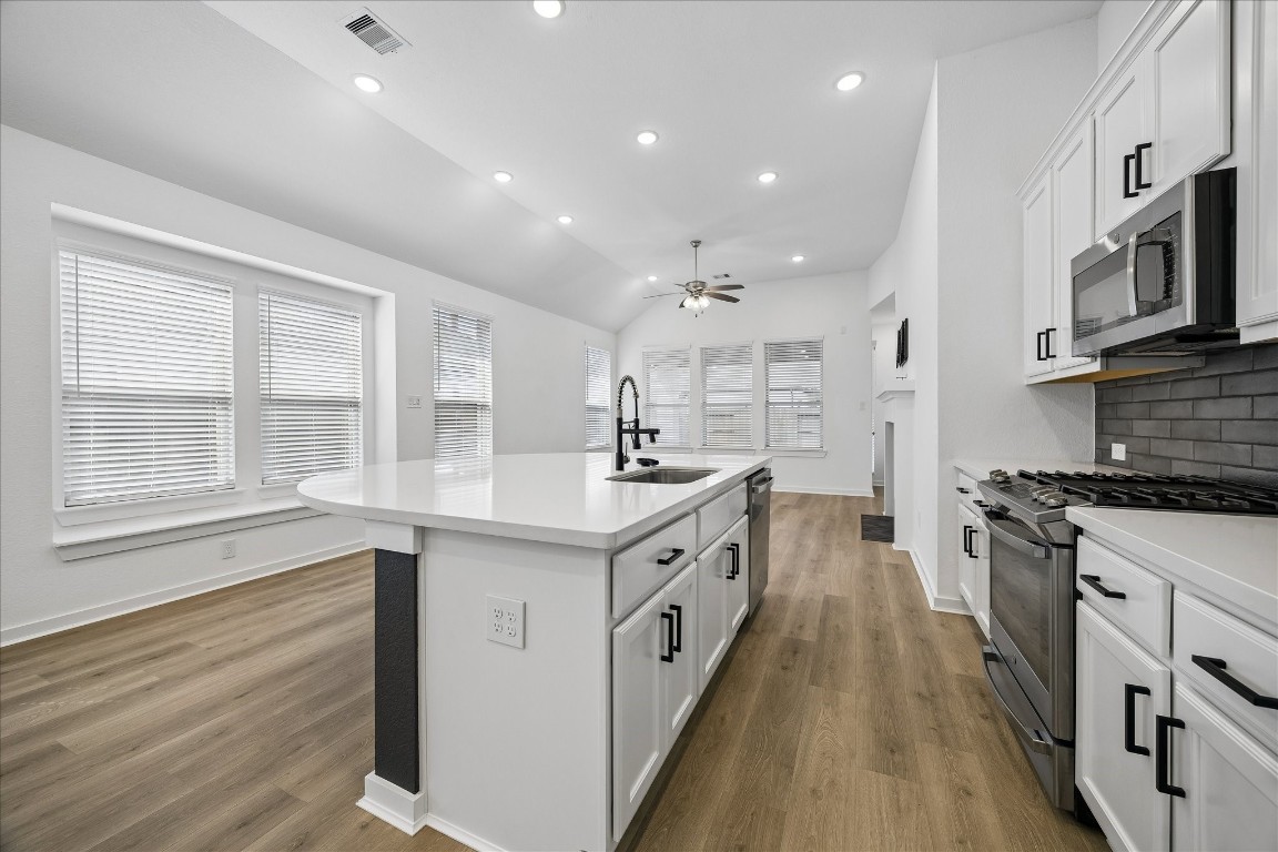 15823 Bird Of Conroe, TX 77302 - Photo 9 of 27 a large kitchen with stainless steel appliances granite countertop a lot of counter space and wooden floors