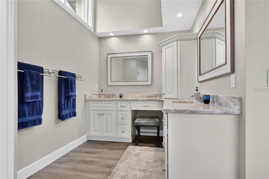 9426 Palm Tree Drive Windermere, FL 34786 - Photo 12 of 29 a bathroom with a granite countertop sink a toilet and a mirror