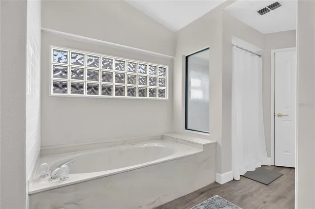 a white bath tub sitting next to a window