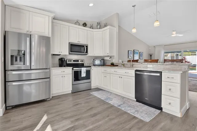 a kitchen with white cabinets and white appliances