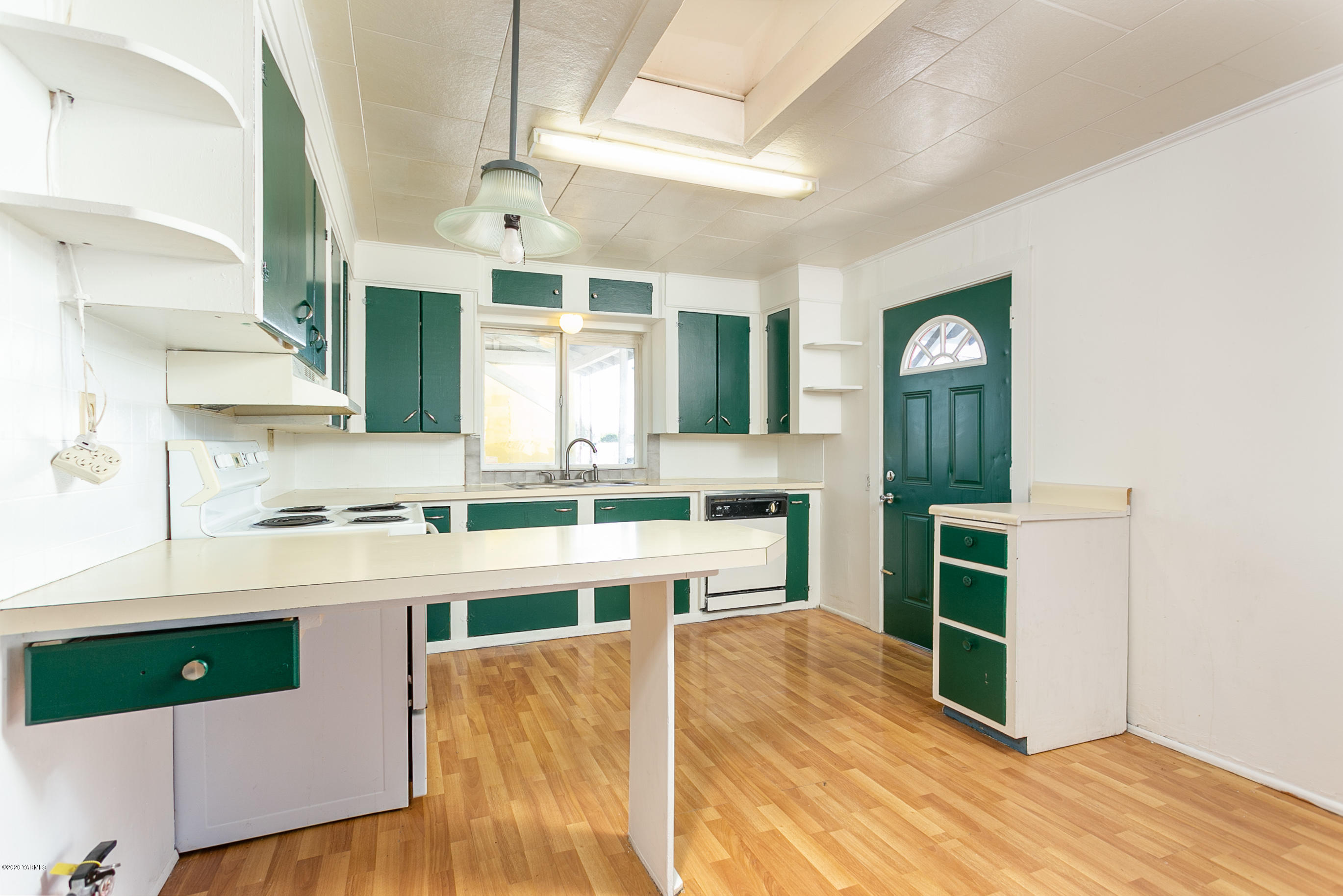 605 Wine Country Road Grandview, WA 98930 - Photo 14 of 22 a kitchen with stainless steel appliances a stove a sink cabinets and wooden floor