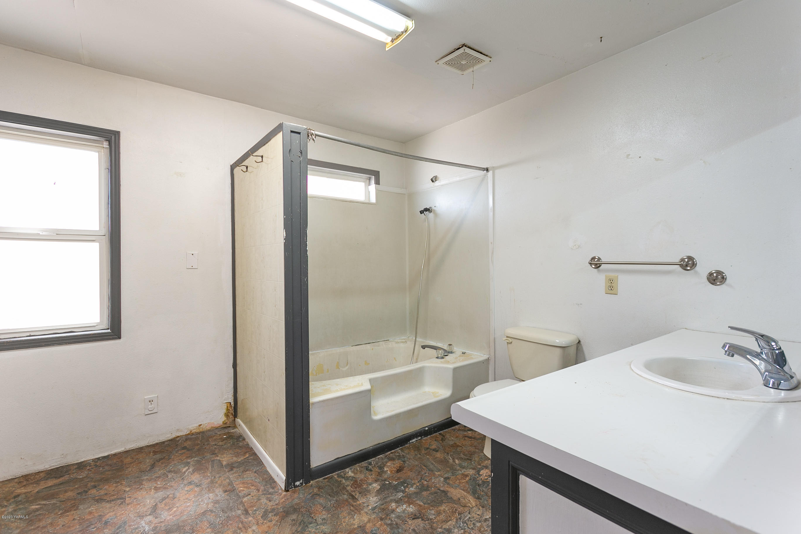 605 Wine Country Road Grandview, WA 98930 - Photo 22 of 22 a bathroom with a sink a toilet and shower