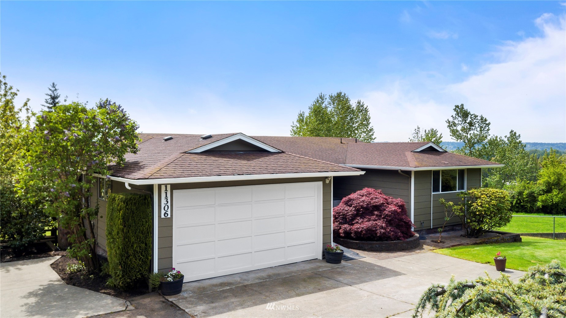 11306 Karshner Road East Edgewood, WA 98372 - Photo 1 of 31 a front view of a house with garden