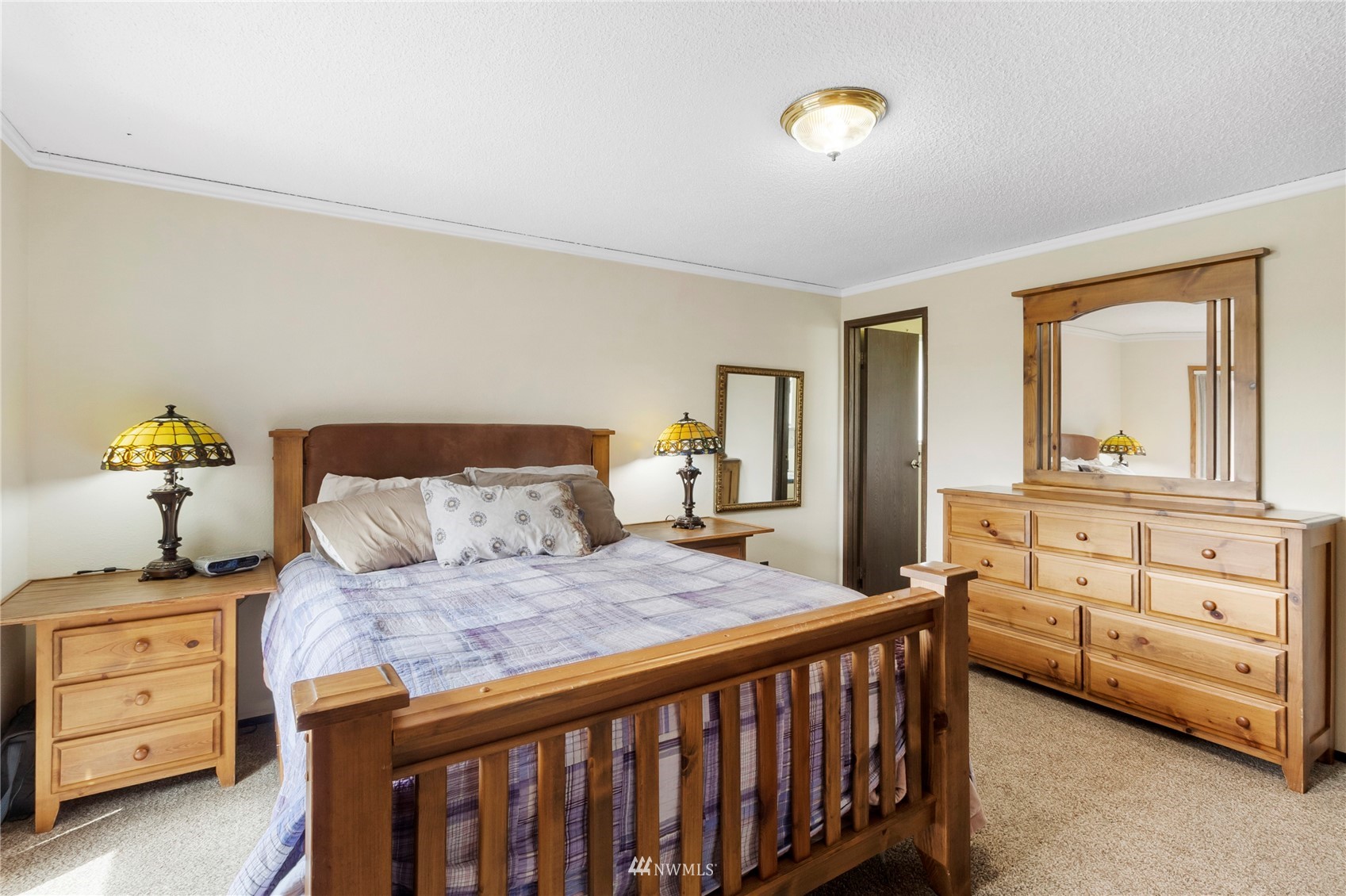 11306 Karshner Road East Edgewood, WA 98372 - Photo 11 of 31 a bedroom with a bed and a dresser