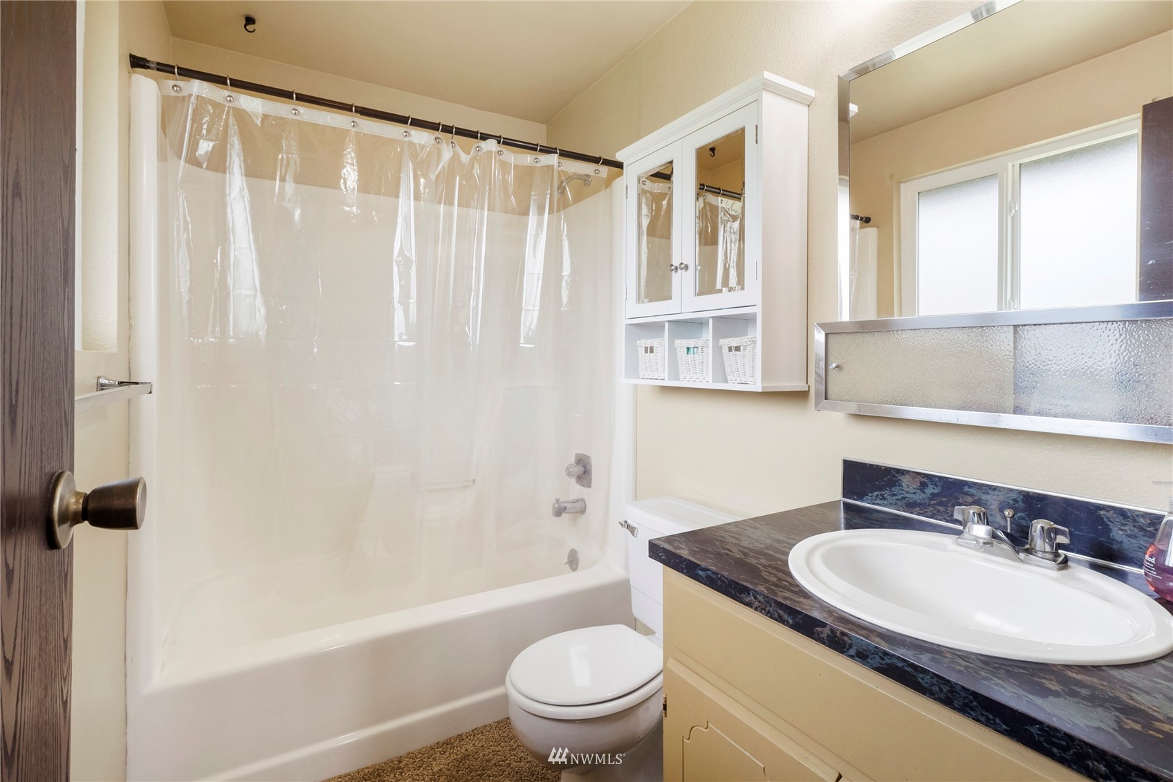 11306 Karshner Road East Edgewood, WA 98372 - Photo 12 of 31 a bathroom with a sink a toilet and a large mirror
