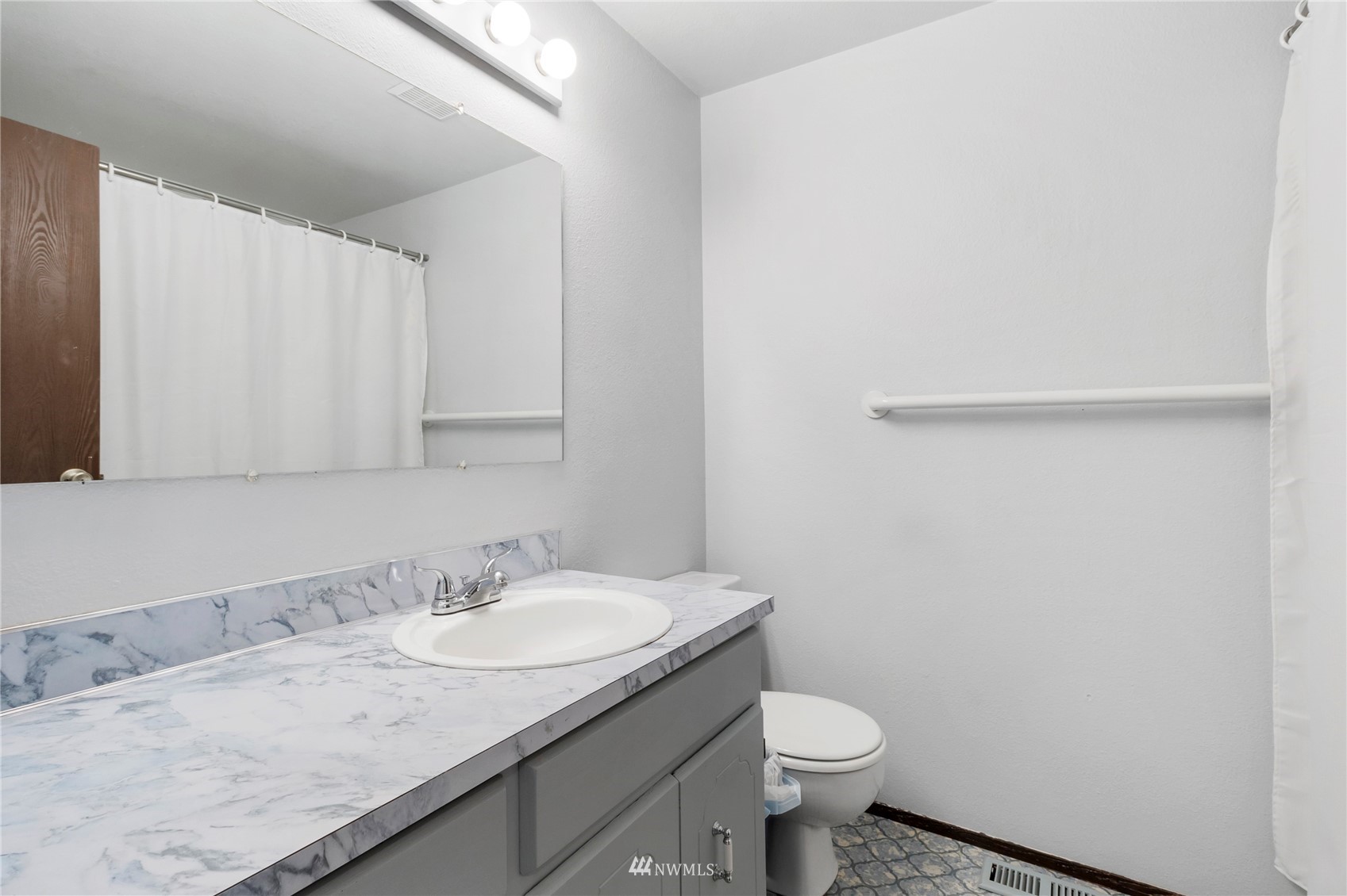 11306 Karshner Road East Edgewood, WA 98372 - Photo 16 of 31 a bathroom with a granite countertop sink and a toilet
