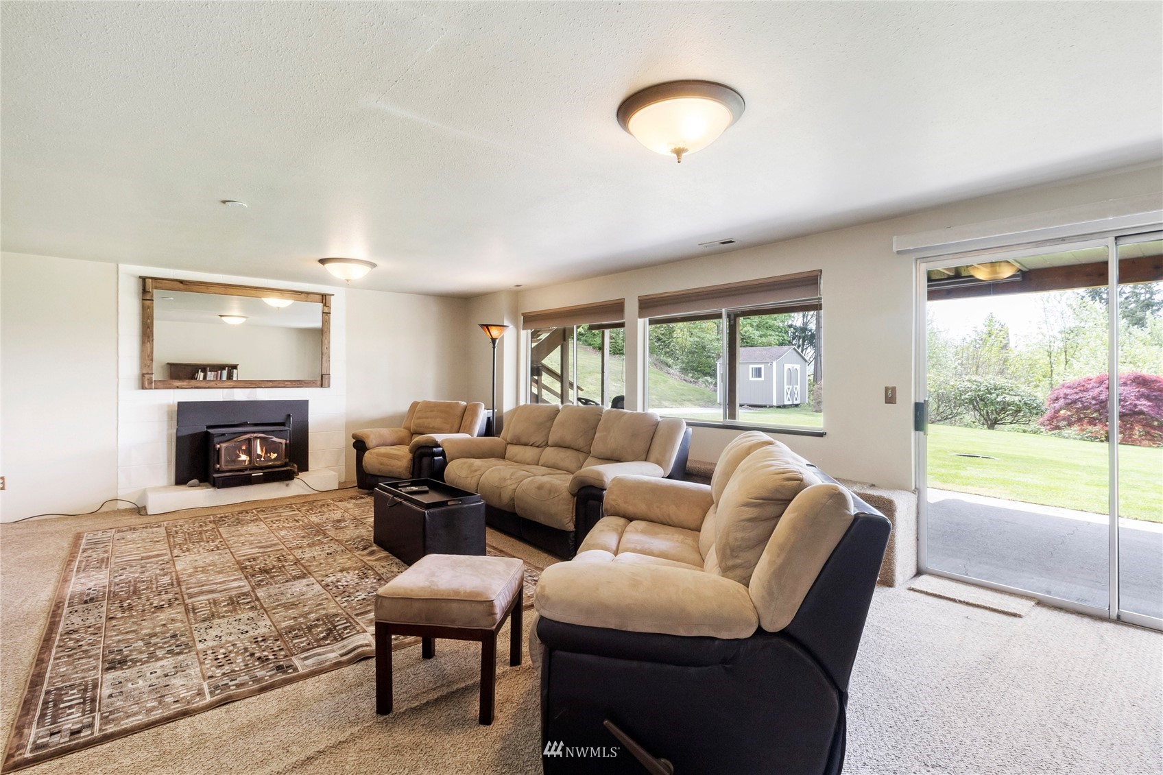 11306 Karshner Road East Edgewood, WA 98372 - Photo 18 of 31 a living room with furniture and a fireplace