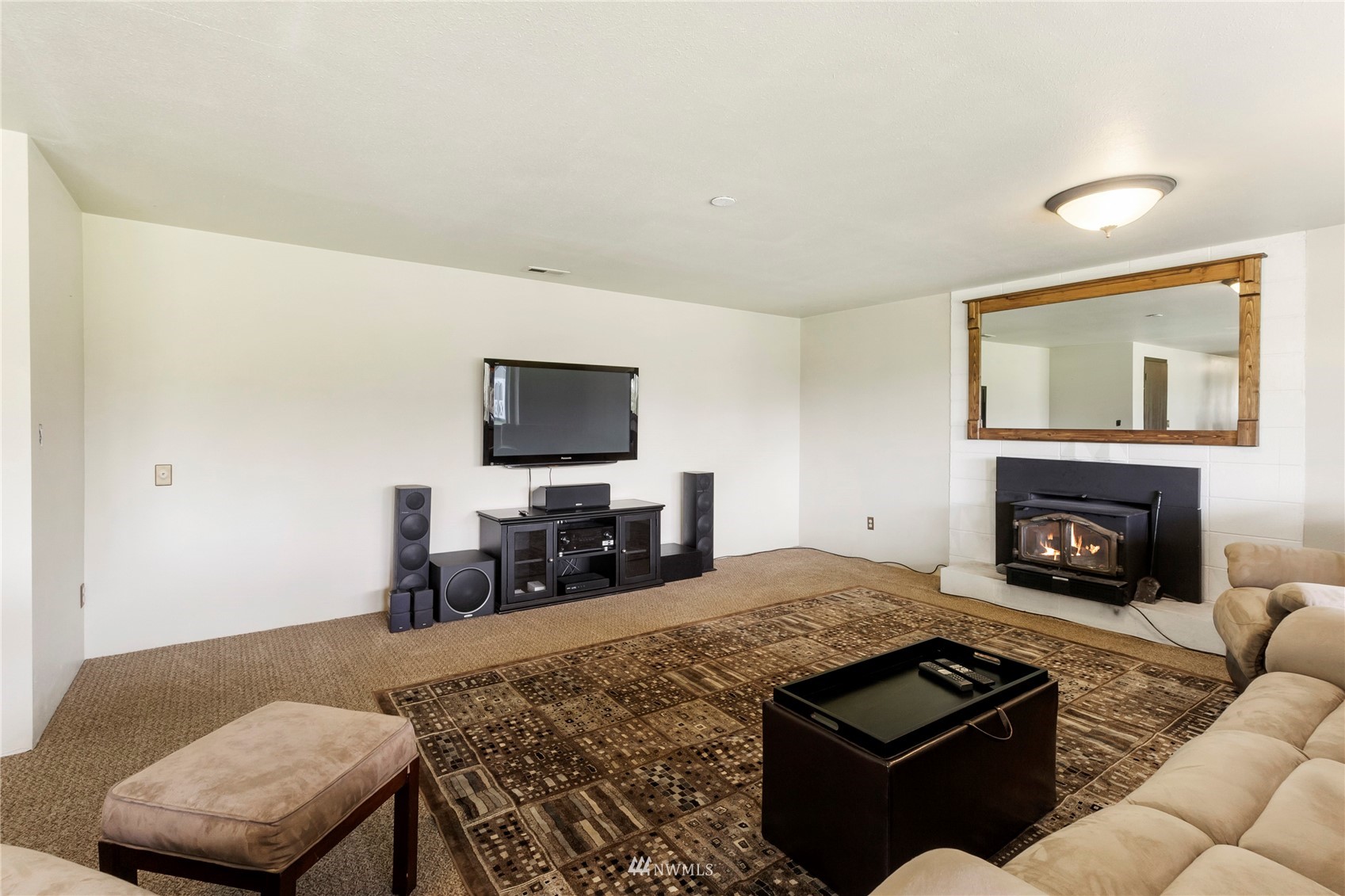 11306 Karshner Road East Edgewood, WA 98372 - Photo 19 of 31 a living room with furniture and a fireplace