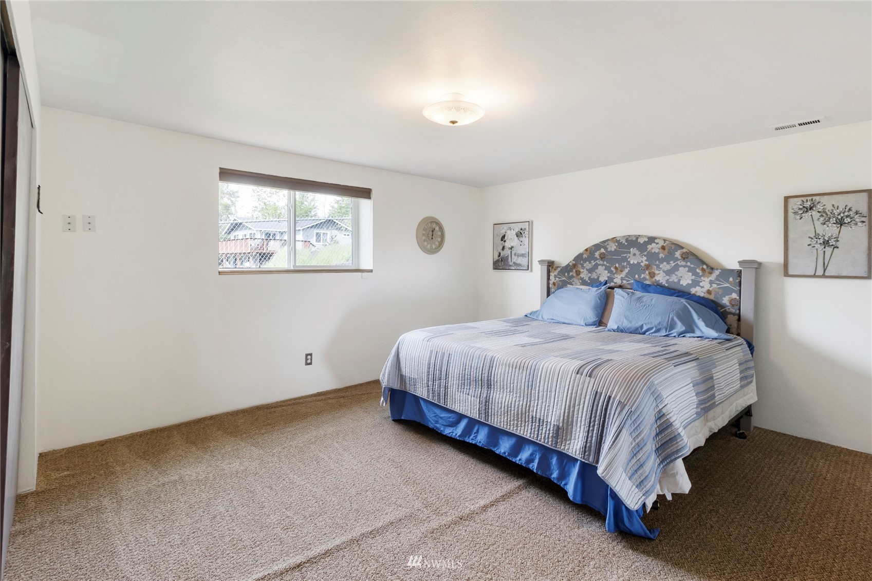11306 Karshner Road East Edgewood, WA 98372 - Photo 20 of 31 a bedroom with a bed and wall painting