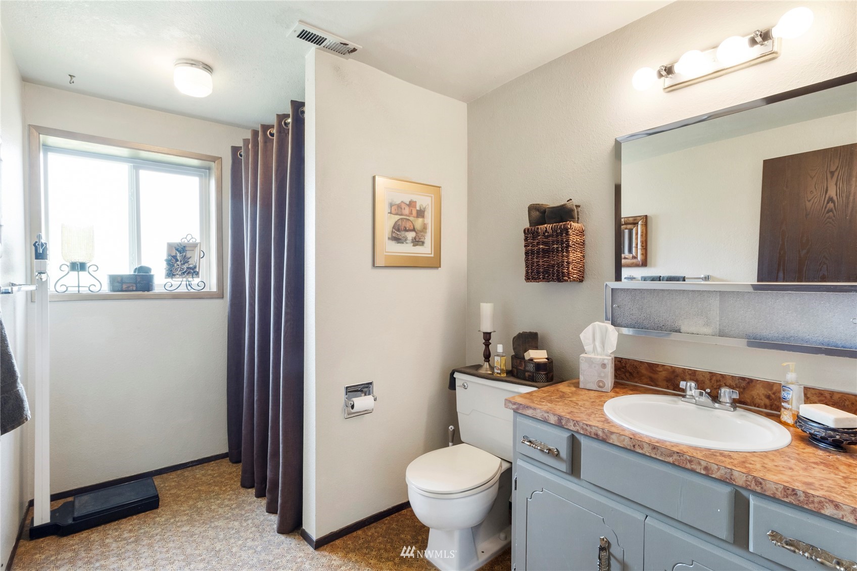 11306 Karshner Road East Edgewood, WA 98372 - Photo 22 of 31 a bathroom with a granite countertop toilet sink and mirror