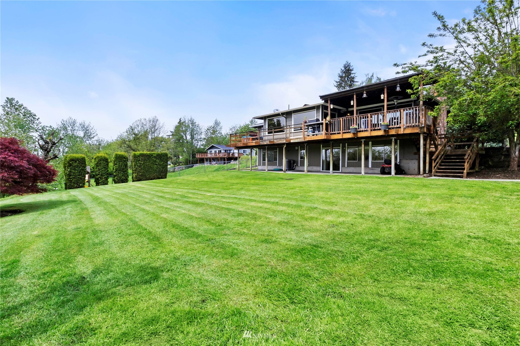 11306 Karshner Road East Edgewood, WA 98372 - Photo 26 of 31 a view of a house next to a big yard and large trees