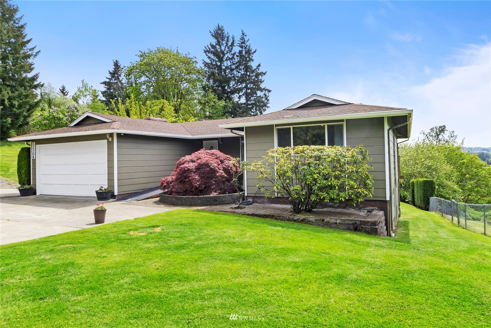 11306 Karshner Road East Edgewood, WA 98372 - Photo 3 of 31 a front view of a house with garden