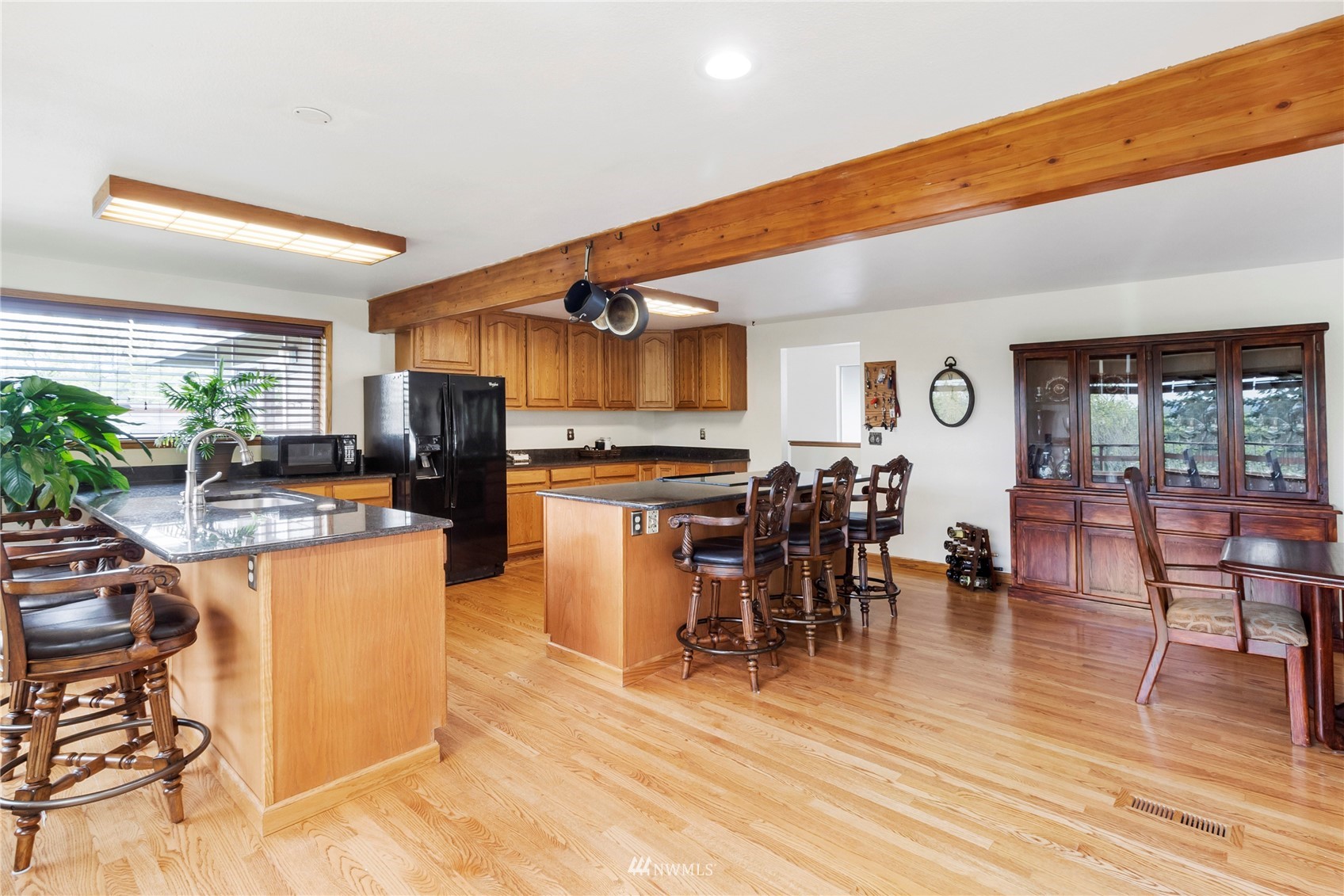 11306 Karshner Road East Edgewood, WA 98372 - Photo 6 of 31 a kitchen with stainless steel appliances a dining table chairs stove and cabinets