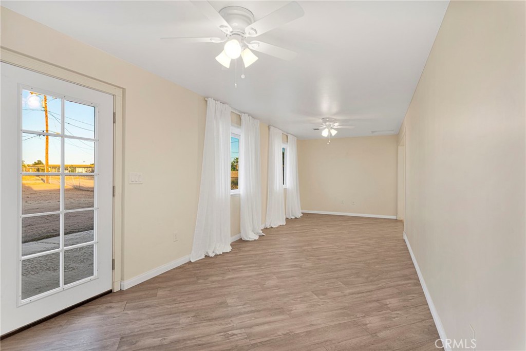 15177 Mendota Road North Apple Valley, CA 92307 - Photo 30 of 50 wooden floor in an empty room with a window