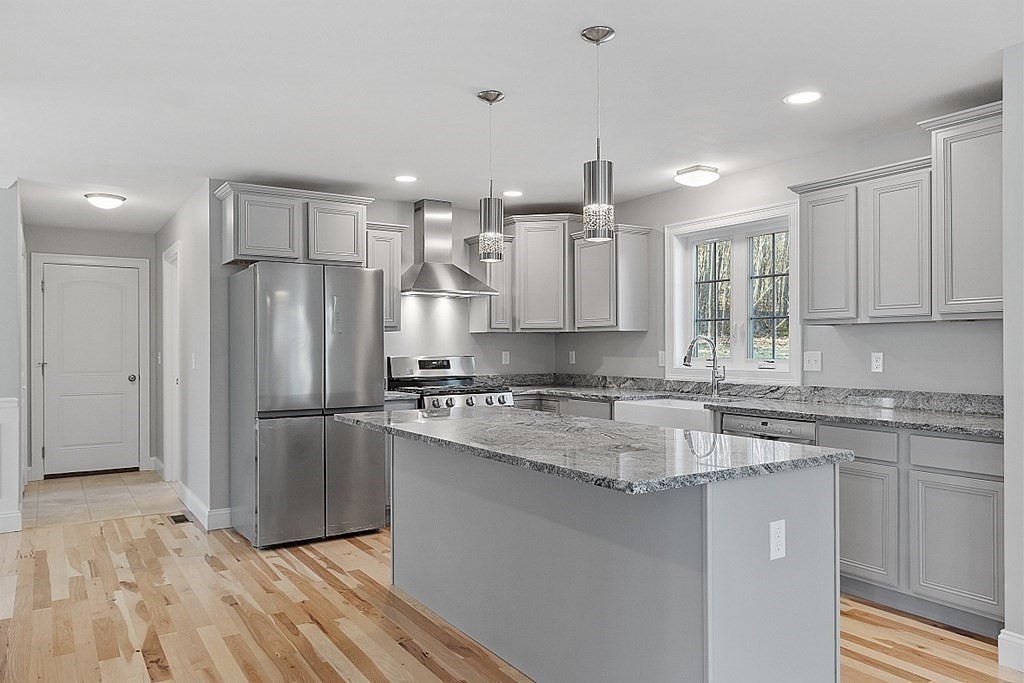 12 Marshall Hill Road, Unit LOT 3 Westminster, MA 01473 - Photo 1 of 42 a kitchen with a refrigerator a sink and white cabinets