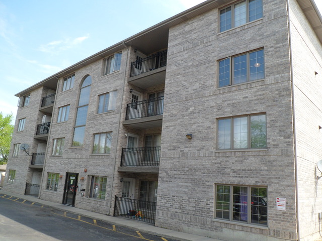 10538 SW Highway, Unit 203B Chicago Ridge, IL 60415 - Photo 1 of 14 a front view of a building with many windows