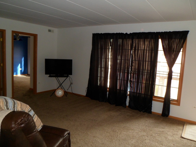 10538 SW Highway, Unit 203B Chicago Ridge, IL 60415 - Photo 2 of 14 a living room with a flat screen tv and a large window