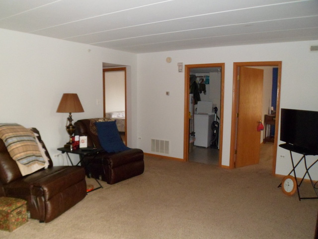 10538 SW Highway, Unit 203B Chicago Ridge, IL 60415 - Photo 3 of 14 a living room with furniture and a flat screen tv