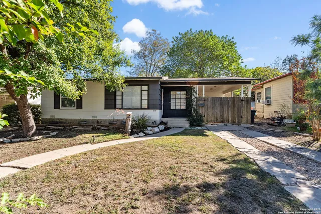 a house that has a tree in front of it