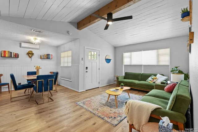 a living room with furniture wooden floor and a table