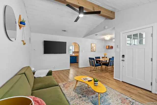a living room with furniture and a flat screen tv
