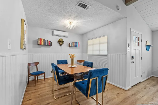 a view of a dining room with furniture and a chandelier