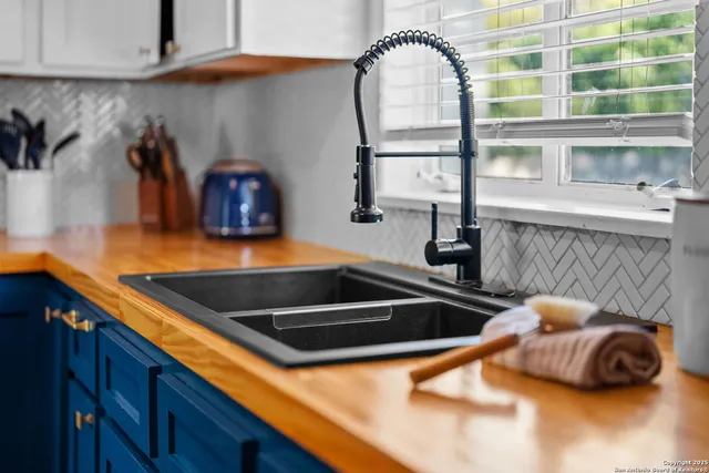 a kitchen with a sink and a stove next to a window