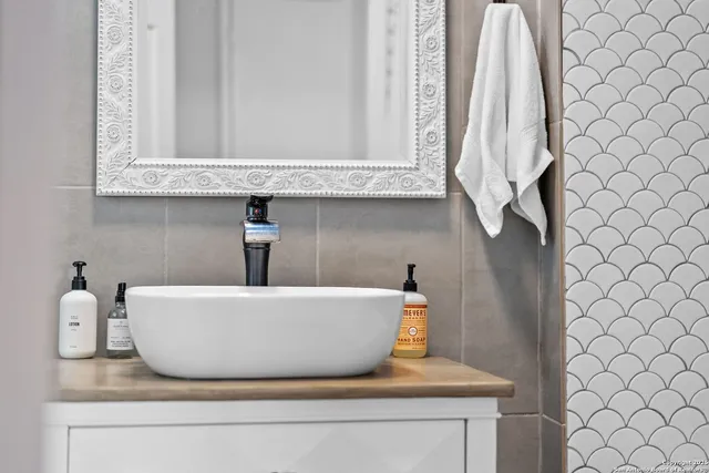 a white bath tub sitting next to a white cabinet