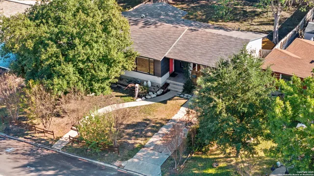 a view of a house with a yard and sitting area