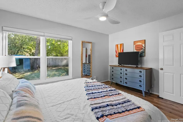 a bedroom with furniture and a flat screen tv