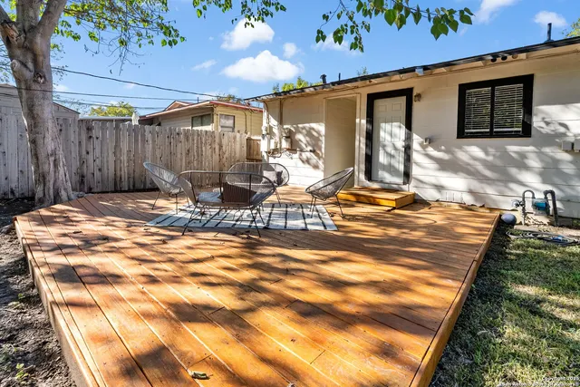 a outdoor space with pool table and chairs